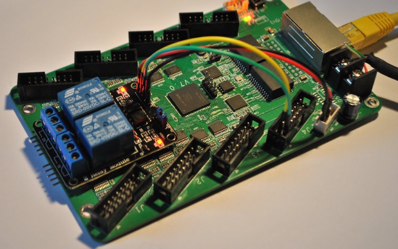 A ColorLight 5A-75B board with a two-channel relay module wired to its HUB75 connector and an Ethernet cable